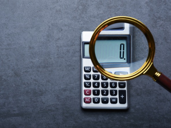 Calculator showing zero under magnifying glass